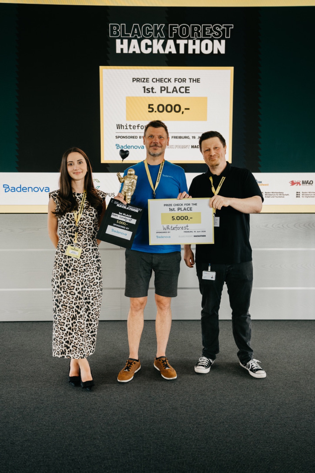 Adam Lundqvist with the first-place trophy and the EUR 5,000 prize check for team Whiteforest at the Black Forest Hackathon award ceremony